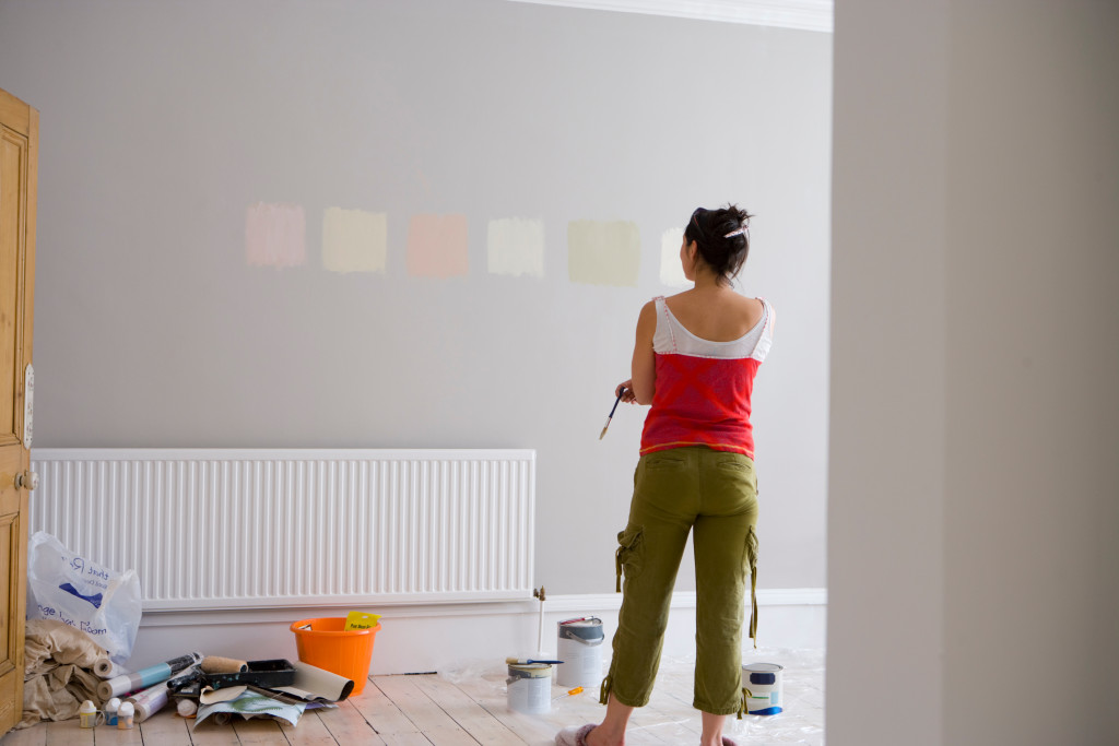 woman deciding on wall paint